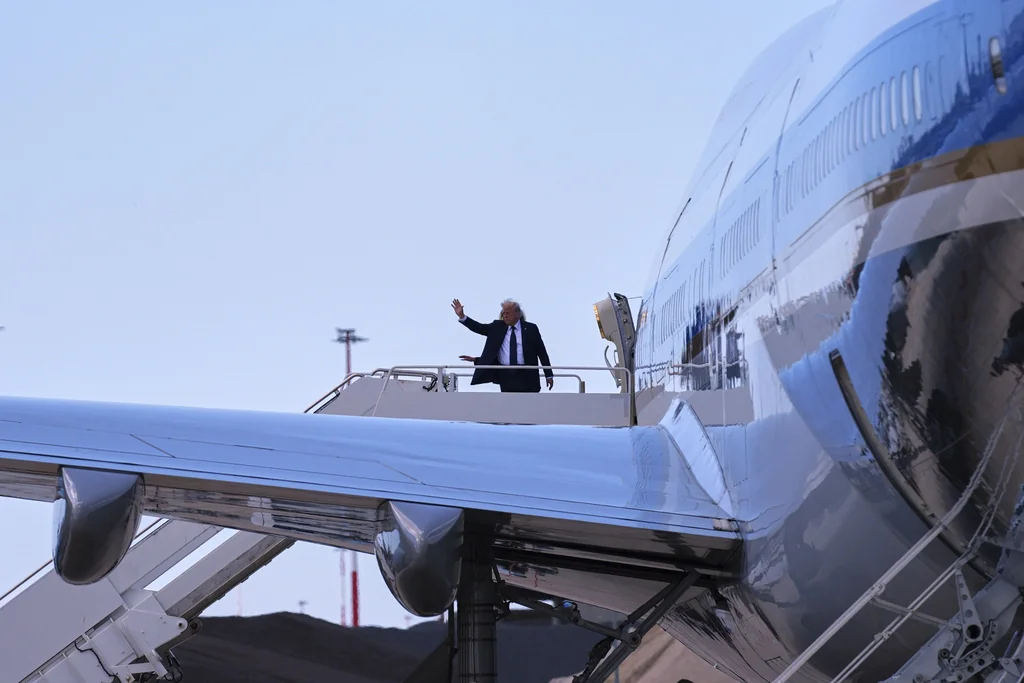 President Donald Trump and first lady Melania Trump wave before they board Air Force One