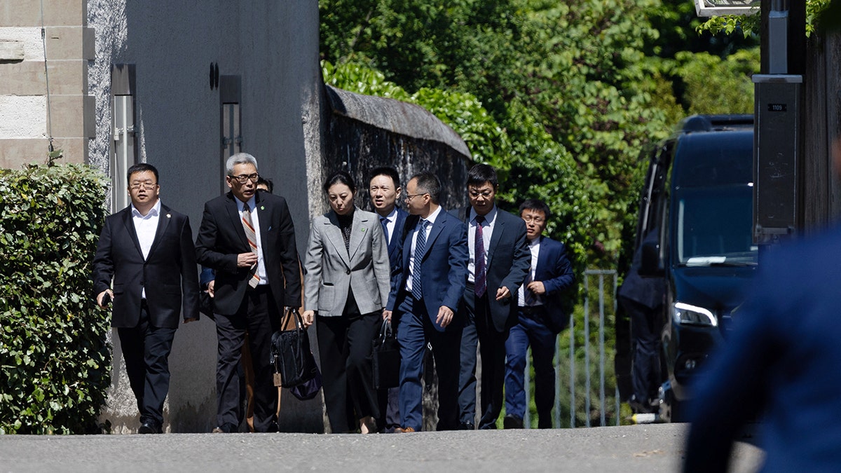 Members of the Chinese delegation leave a residence where trade talks between Chinese and U.S. delegations take place in Geneva