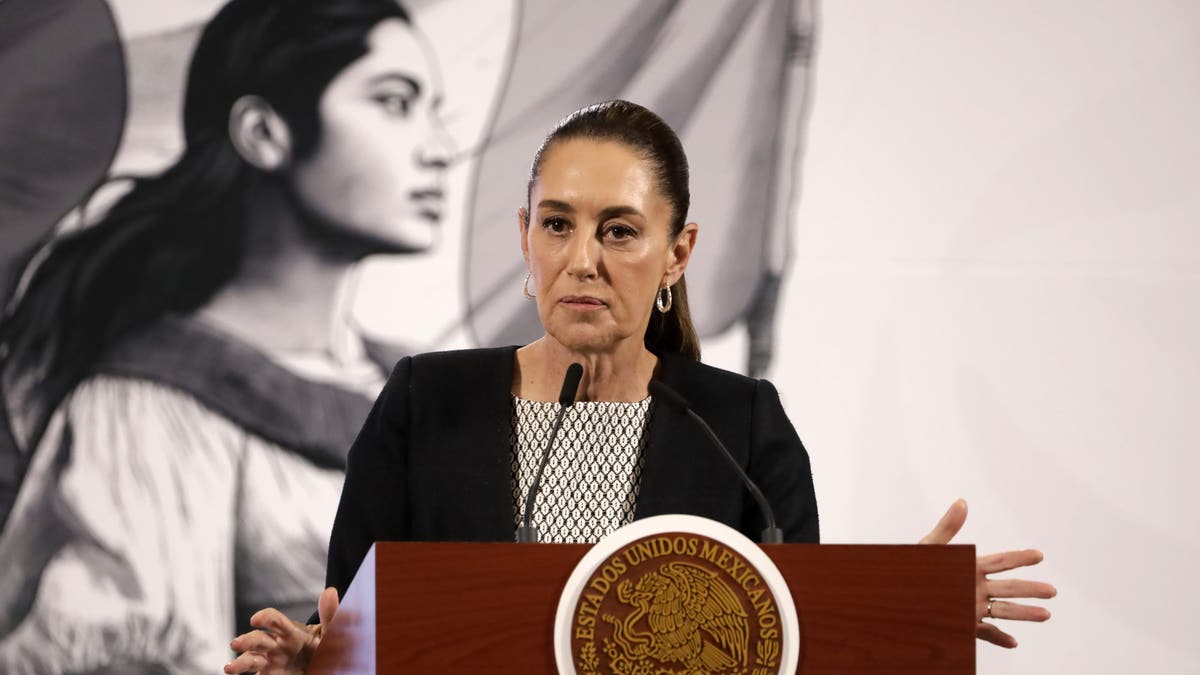 Mexican president speaking at podium while wearing black attire