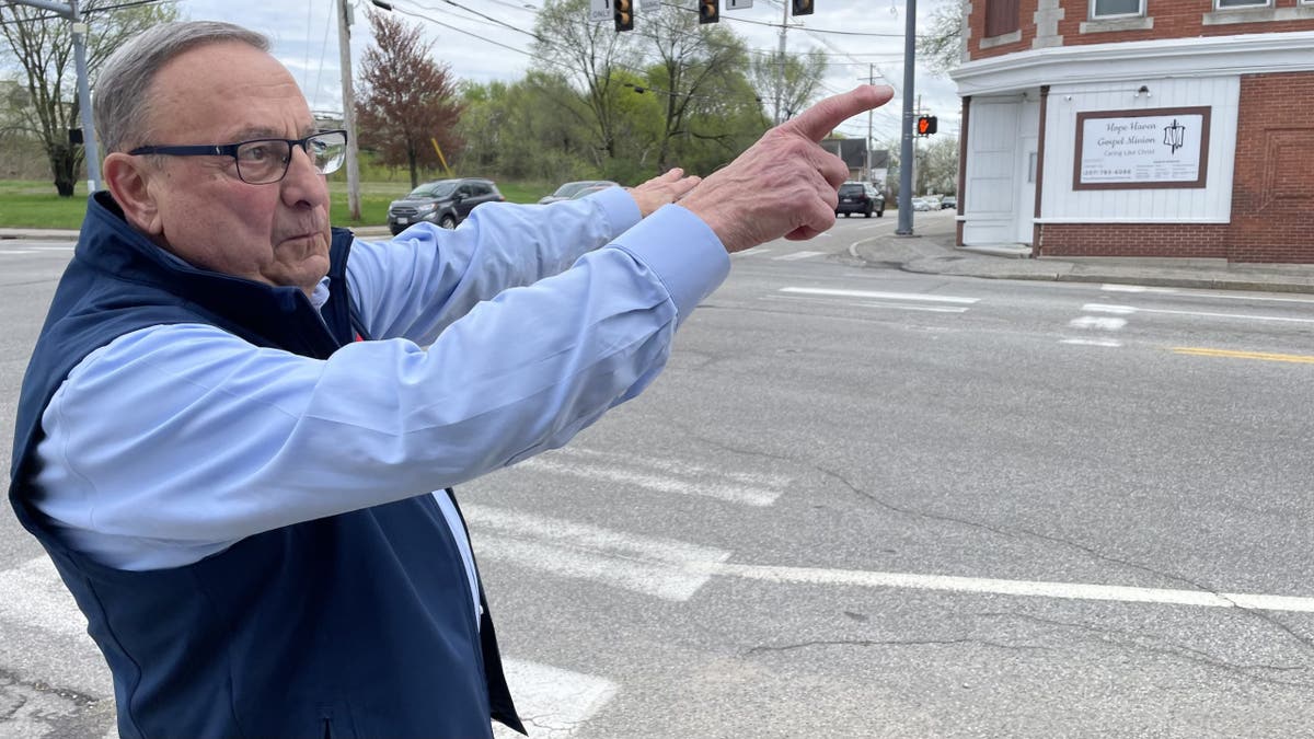 Former Maine Gov. Paul LePage points in the location of a building where he lived during his childhood, in Lewiston, Maine, on May 7, 2025.