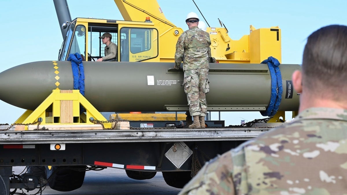 airmen moving a bomb