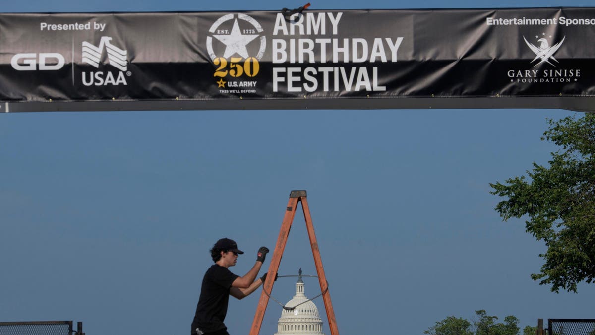 Crews work on setting up an archway on the National Mall, during preparations for an upcoming military parade commemorating the Army's 250th anniversary and coinciding with President Donald Trump's 79th birthday, Thursday, Jun. 12, 2025, in Washington. 
