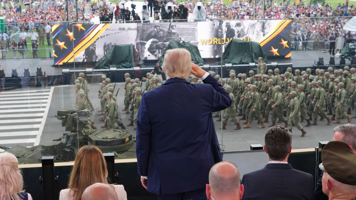 President Donald Trump, center, salutes passing troops during a parade to honor the Army's 250th anniversary, coinciding with Trump's 79th birthday, June 14, 2025, in Washington.