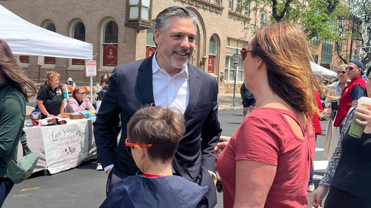 Republican gubernatorial candidate Bill Spadea talks with voters at a street fair in Somerville, New Jersey, on June 1, 2025.