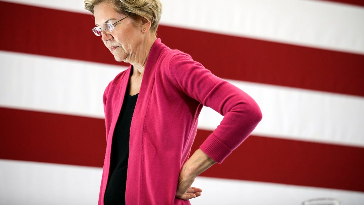 Sen. Warren closeup shot, large US flag behind her
