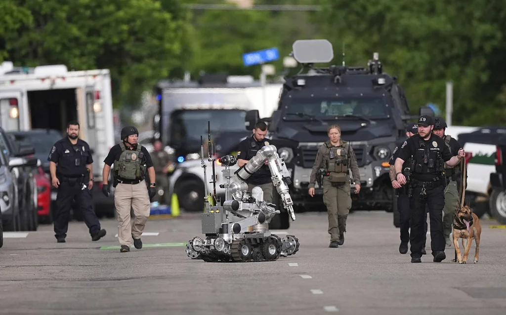 Law enforcement officials investigate after an attack on the Pearl Street Mall Sunday, June 1, 2025, in Boulder, Colo.