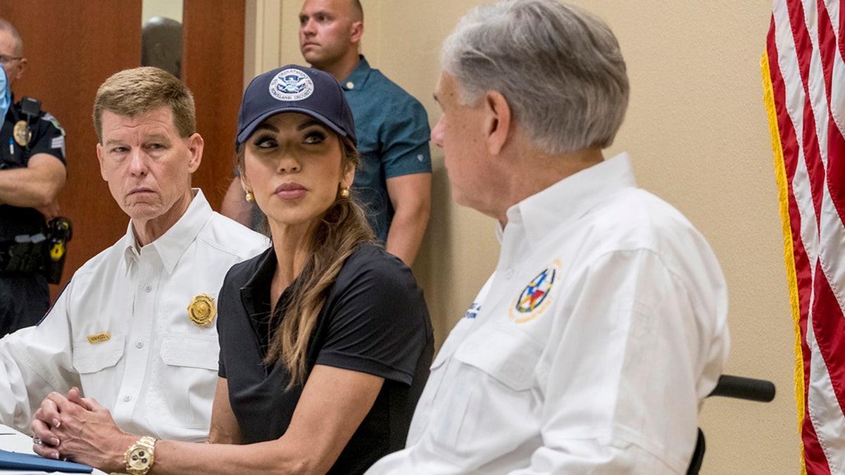 Homeland Security Secretary Kristi Noem and Gov. Greg Abbott, discuss the ongoing efforts for recent flooding along the Guadalupe River during a news conference in Ingram, Texas, on Saturday, July 5, 2025, as Texas Division of Emergency Management Chief, Nim Kidd, left, looks on.