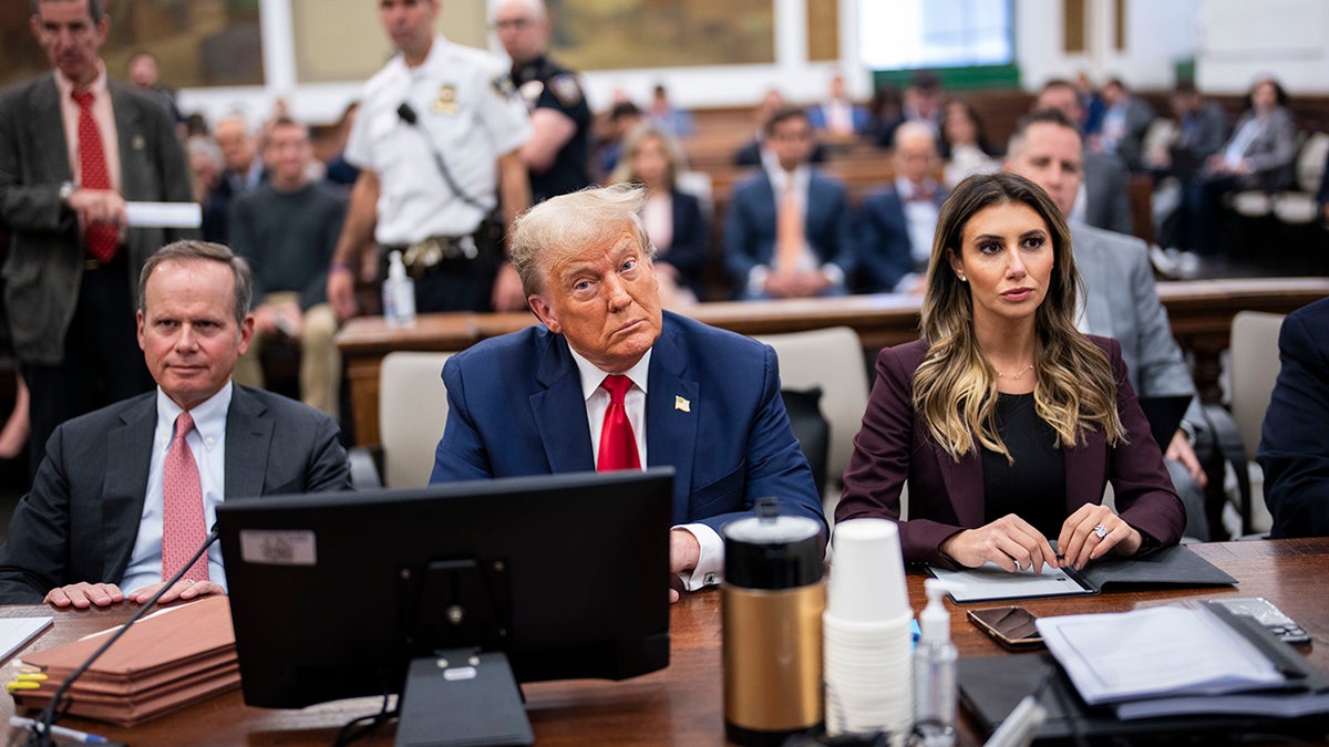 Donald Trump with Alina Habba to his left at witness table