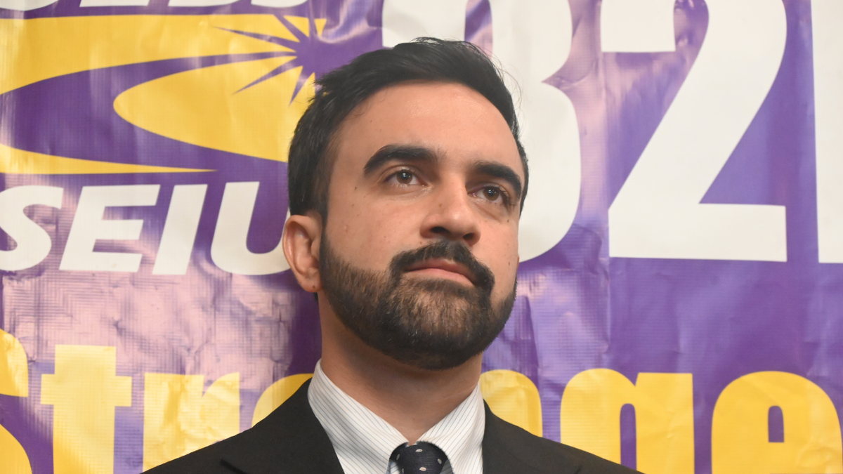 Mamdani closeup with SEIU banner behind him