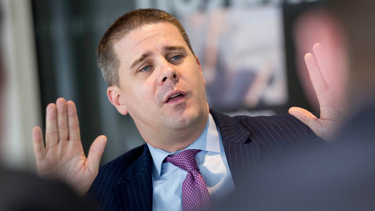 Pfeiffer puts his hands up during an interview