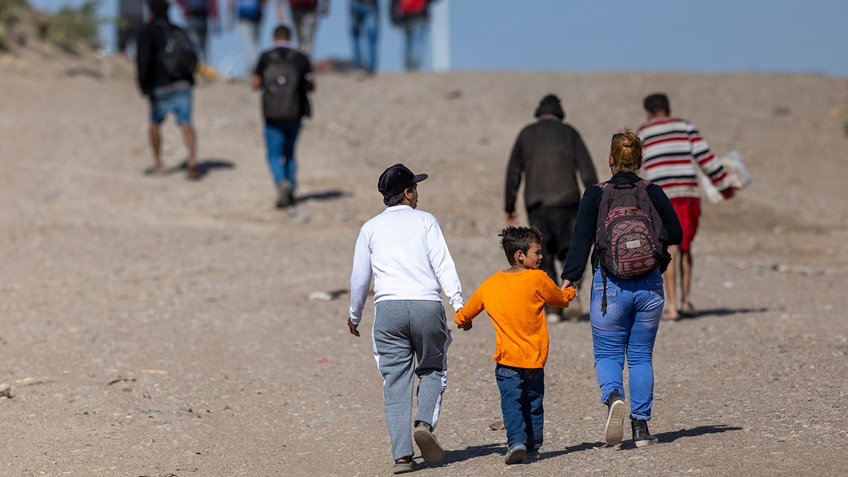 migrants walking in desert