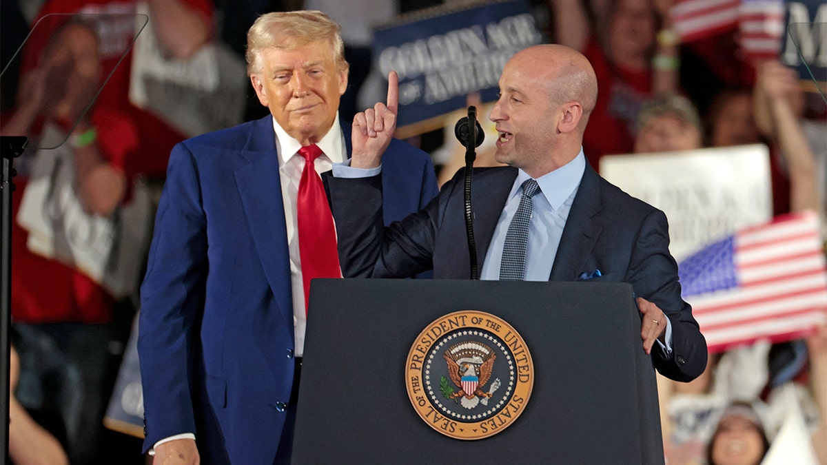 White House deputy chief of staff for policy and US homeland security advisor Stephen Miller (R) speaks as US President Donald Trump delivers a speech in Warren, Michigan, on April 29, 2025.