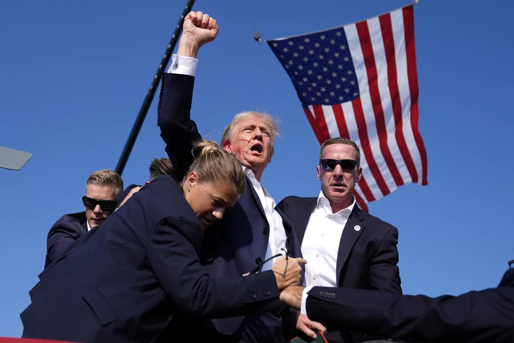 Republican presidential candidate former President Donald Trump is surrounded by U.S. Secret Service agents at a campaign rally, July 13, 2024, in Butler, Pa. President-elect Donald Trump will choose Sean Curran, right, as Secret Service Director.