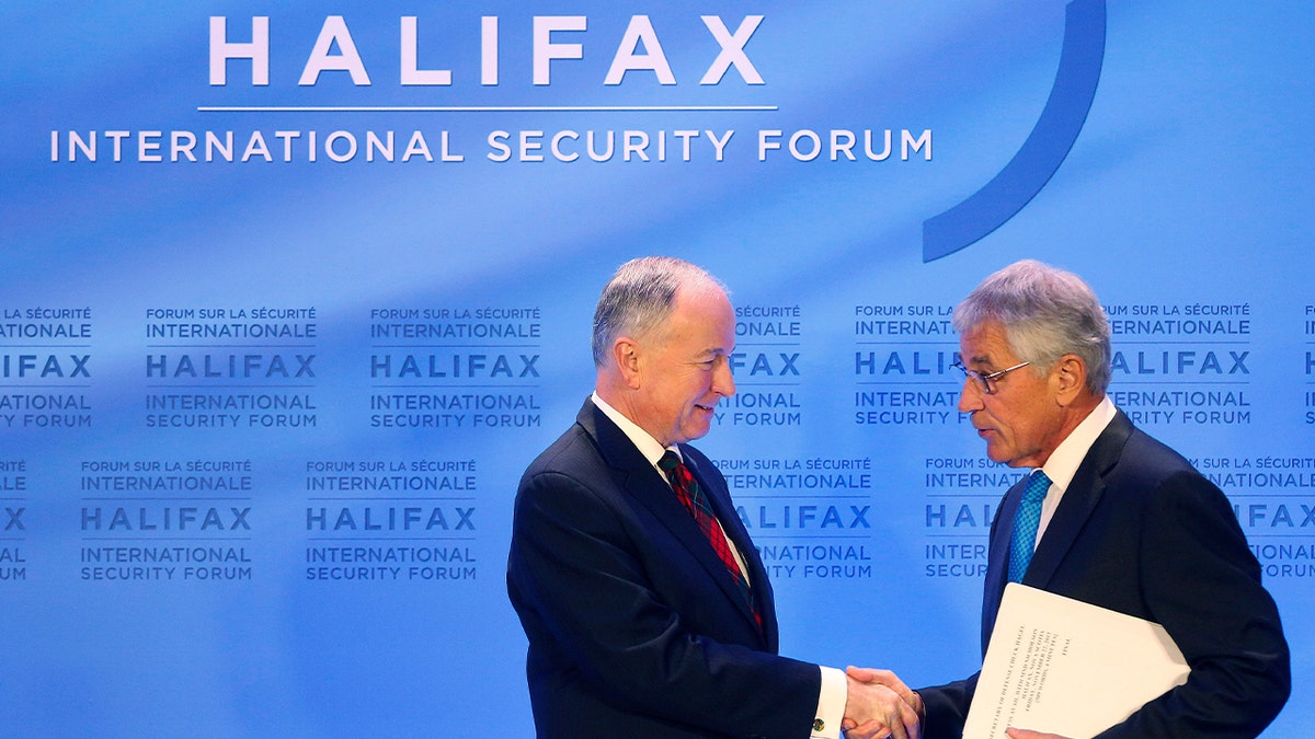 Canadian Minister of National Defence Nicholson and U.S. Defense Secretary Hagel shake hands following the signing of the Canada-U.S. Asia-Pacific Defense Policy Cooperation Framework in Halifax