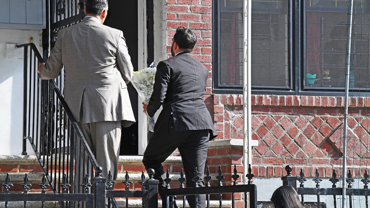 Mamdani on stoop of Islam family home