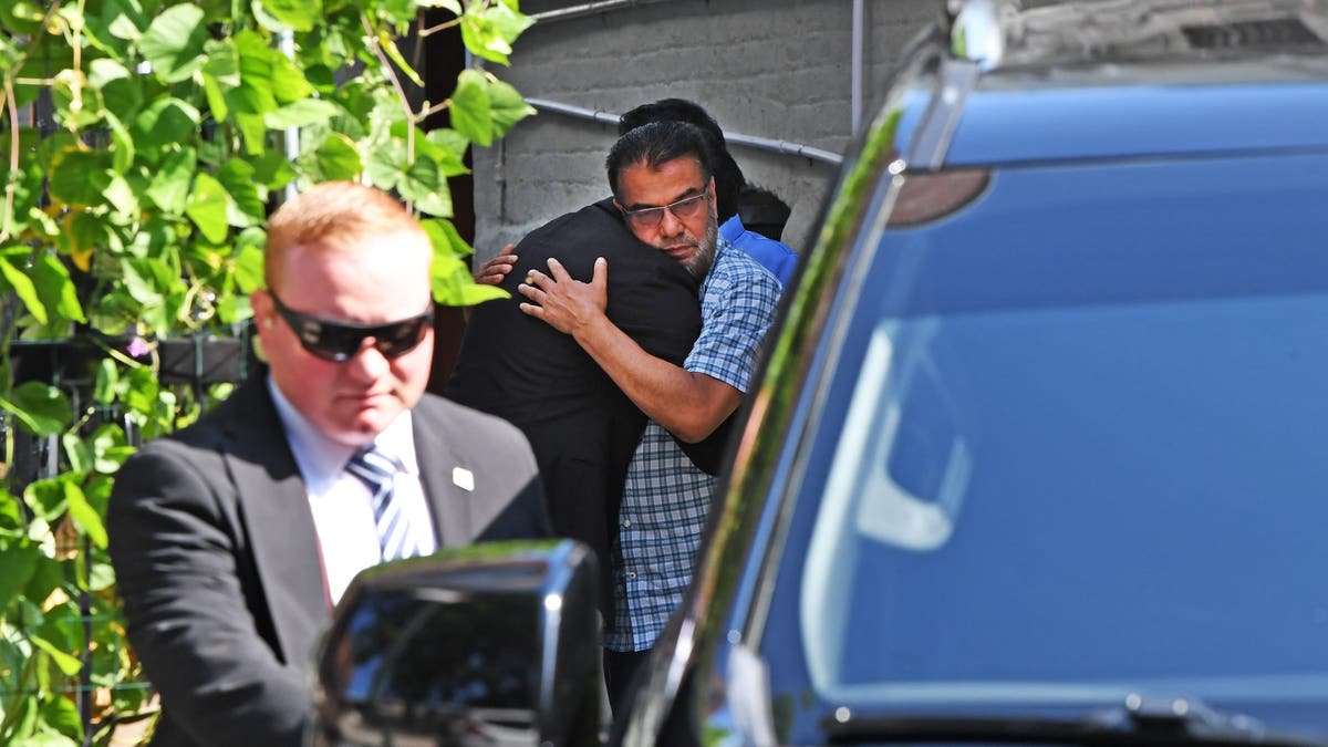 Mamdani hugs man outside Islam family home