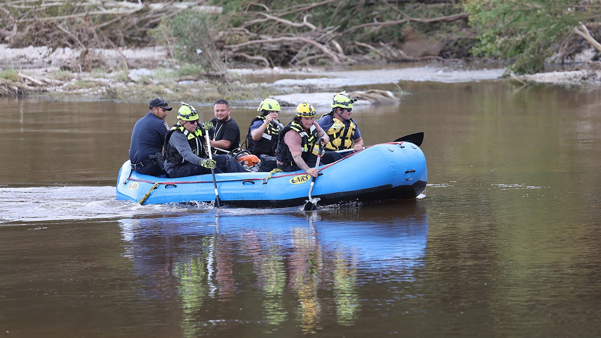 Recover team looking for missing bodies in water after floods.