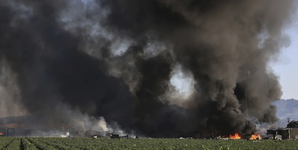 Smoke and flames rise during a fireworks warehouse explosion near Esparto, Calif., Tuesday, July 1, 2025.