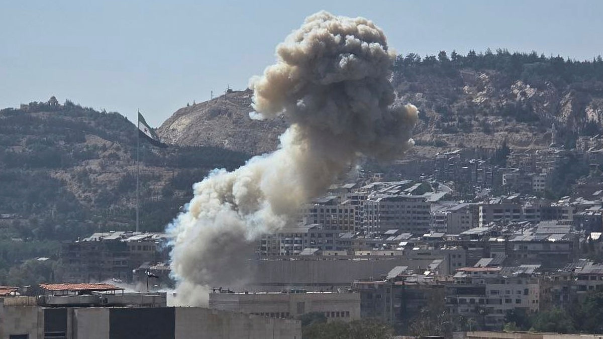 smoke billowing from Syrian capital