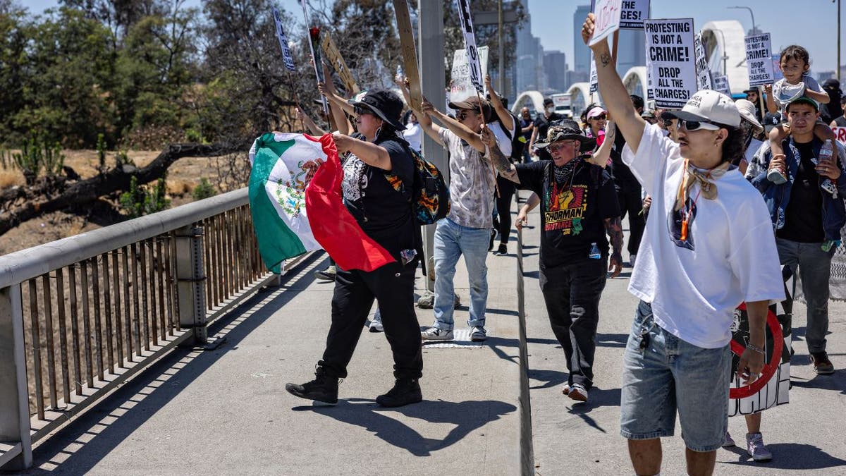 Several dozen protesters stage a demonstration on the Sixth Street Bridge between downtown Los Angeles and Boyle Heights protesting ICE deportations.