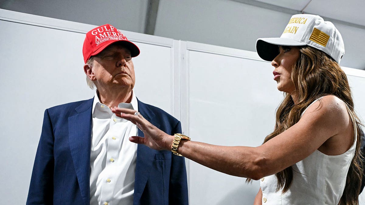 US President President Donald Trump speaks with Secretary of Homeland Security Kristi Noem as they tour a migrant detention center, dubbed "Alligator Alcatraz," located at the site of the Dade-Collier Training and Transition Airport in Ochopee, Florida on July 1, 2025.