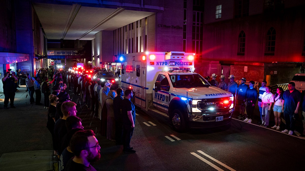 Ambulance carrying fallen NYPD officer