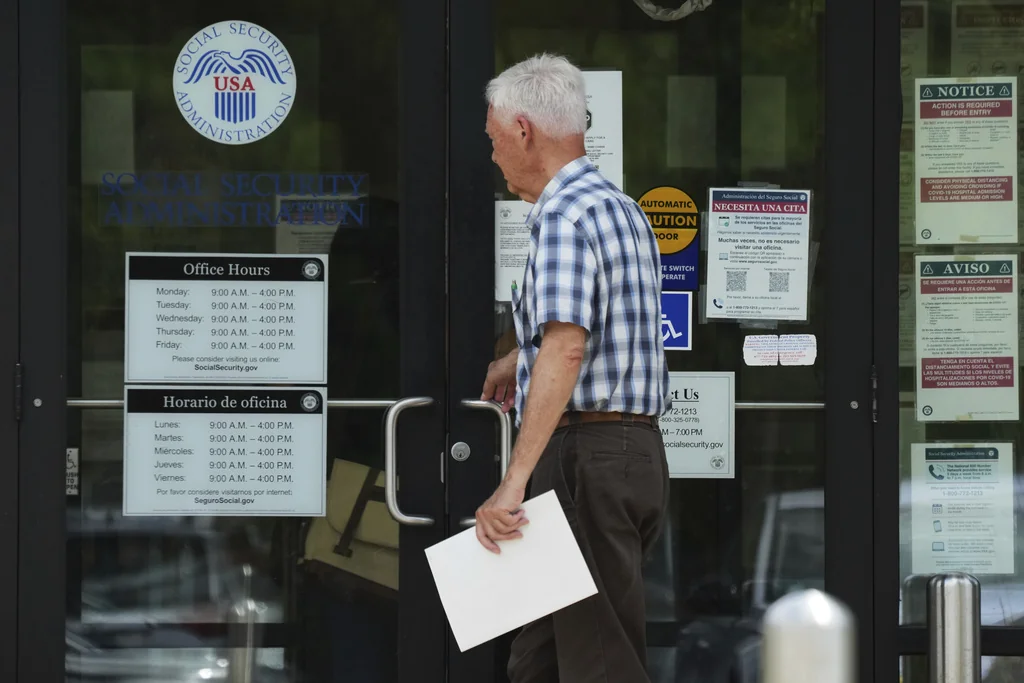 A man walks to a U.S. Social Security Administration office Monday, June 30, 2025, in Mount Prospect, Ill. (AP Photo/Nam Y. Huh)