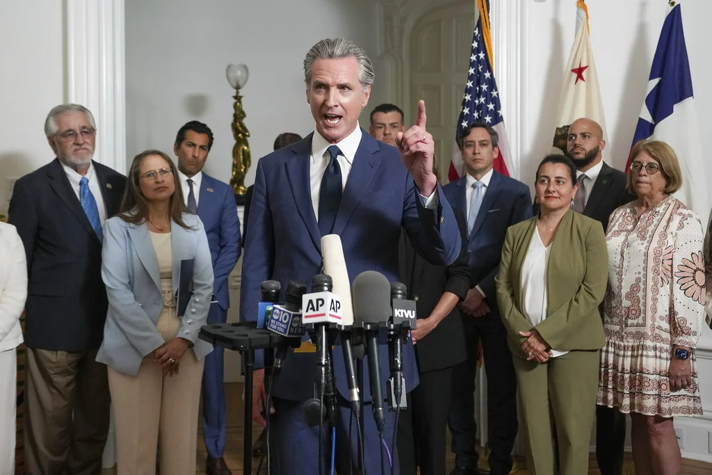 Accompanied by California and Texas lawmakers, California Gov. Gavin Newsom, center, discusses the push to schedule a special election to redraw California's Congressional voting districts, during a news conference in Sacramento, Calif., Friday Aug. 8, 2025. (AP Photo/Rich Pedroncelli)