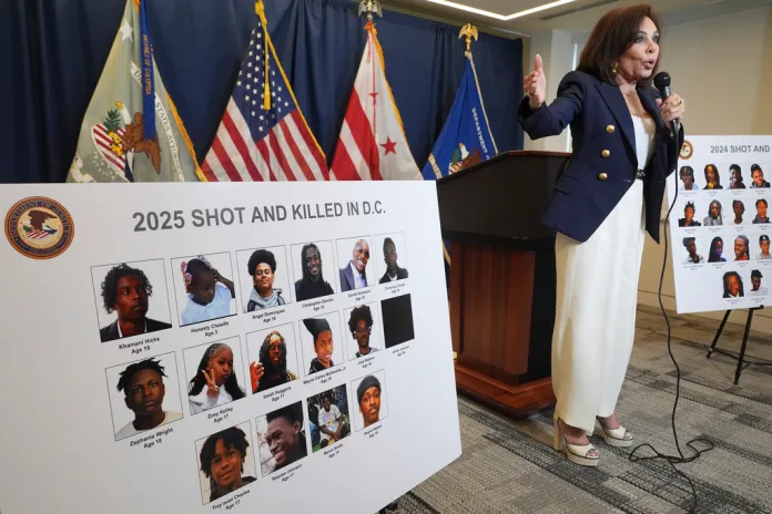 U.S. Attorney for the District of Columbia Jeanine Pirro points to a photo of 3-year-old Ty'ah Settles as she describes murder victims in Washington in 2024, Tuesday, Aug. 12, 2025, during a news conference at the U.S. Attorney's office in Washington. (AP Photo/Jacquelyn Martin)