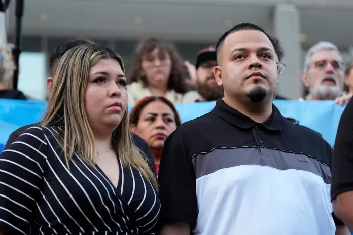 Jennifer Vasquez Sura, left, and her husband Kilmar Abrego Garcia attend a protest rally at the Immigration and Customs Enforcement field office in Baltimore, Monday, Aug. 25, 2025, to support Abrego Garcia. (AP Photo/Stephanie Scarbrough)