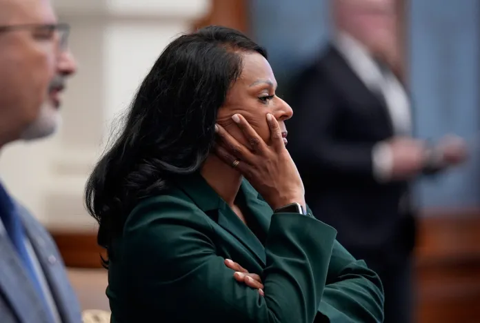 Democratic Texas state Rep. Nicole Collier listens to Texas House Speaker Dustin Burrows announce the need for permission slips for Democratic state representatives to leave the House chamber during the House floor session at the Capitol in Austin, Texas, Monday, Aug. 18, 2025.