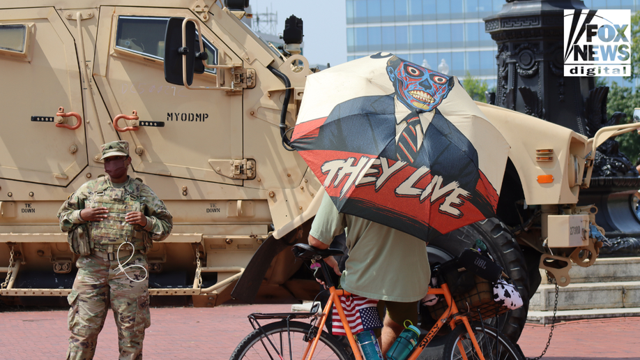 Protester stands with National Guard