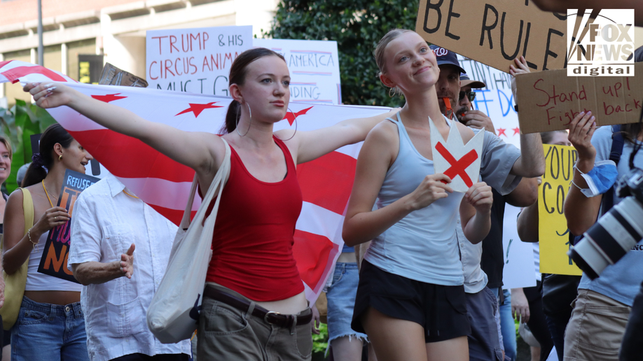 Girls with the DC flag protest Donald Trump