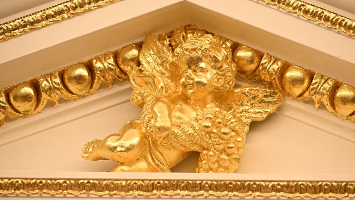 A gold cherub in the Oval Office