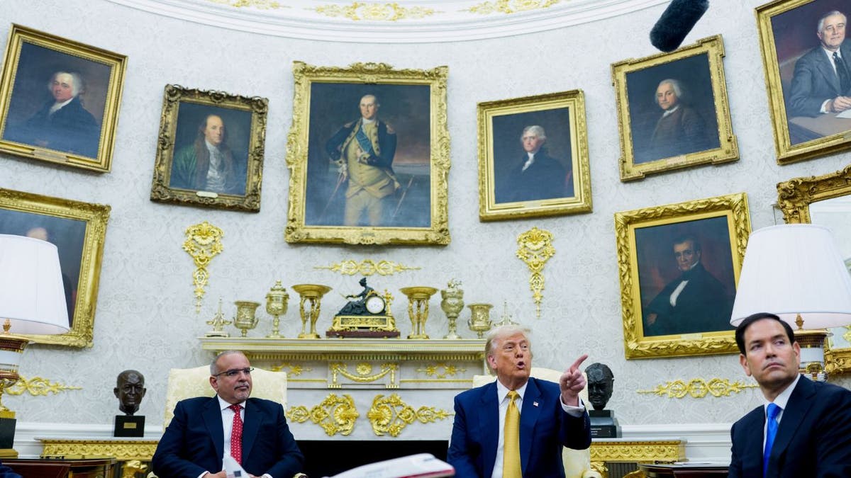 Trump talks to a reporter in the Oval Office