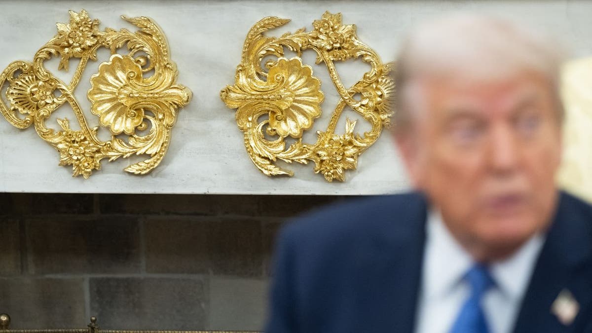 A close view of the gold details on Trump's fireplace in the Oval Office