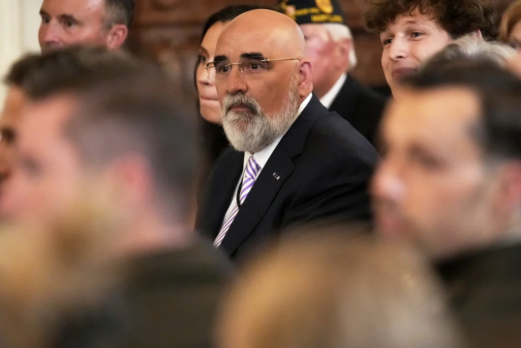 Chris LaCivita listens as President Donald Trump speaks at an event to mark National Purple Heart Day in the East Room of the White House, Thursday, Aug. 7, 2025, in Washington.