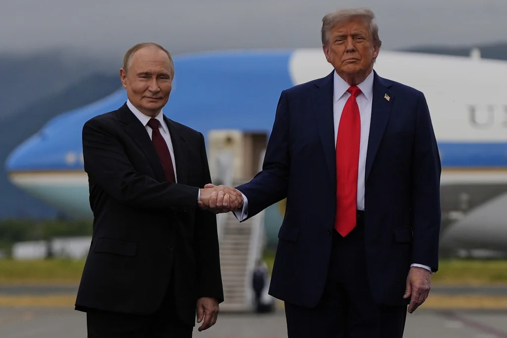President Donald Trump greets Russia's President Vladimir Putin Friday, Aug. 15, 2025, at Joint Base Elmendorf-Richardson, Alaska. (AP Photo/Julia Demaree Nikhinson)