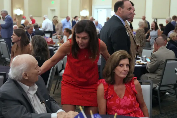 South Carolina Lt. Gov. Pamela Evette, second from left, speaks to a constituent as Attorney General Alan Wilson, right, walks behind her. Evette and Wilson, both running for the GOP gubernatorial nomination, spoke at Rep. Russell Fry's "Freedom Fry" event Monday, Aug. 18, 2025, in Myrtle Beach, S.C. (AP Photo/Meg Kinnard)