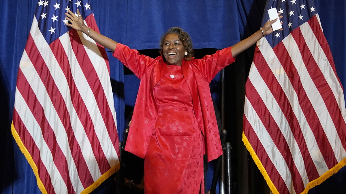 Winsome Sears with her hands in the air