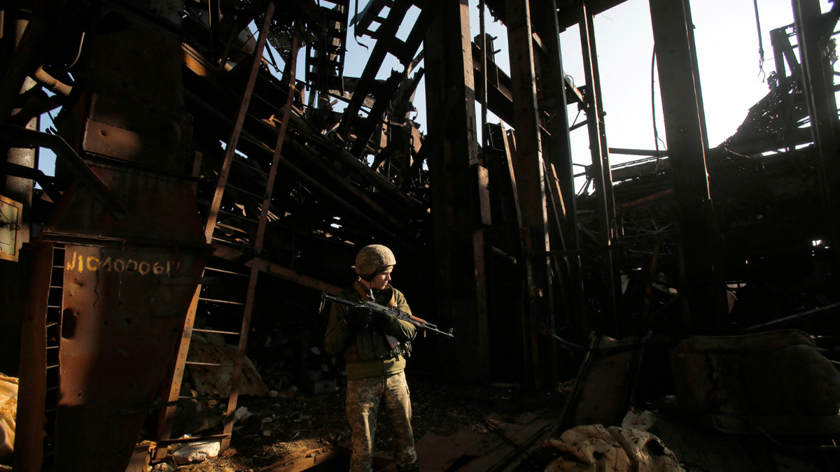 A Ukrainian solider stands in a destroyed coal mine in the Donetsk region