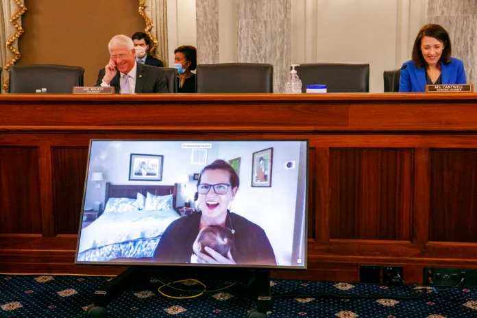 Senate Commerce, Science, and Transportation Committee Chairman Roger Wicker (R-MS), left, and ranking member Maria Cantwell (D-WA) react to the appearance of Rebecca Slaughter, Federal Trade Commissioner holding her newborn daughter Hattie, as she testifies via video conference during a Senate Commerce, Science, and Transportation Committee hearing to examine the Federal Trade Commission, Wednesday, Aug. 5, 2020, on Capitol Hill in Washington.