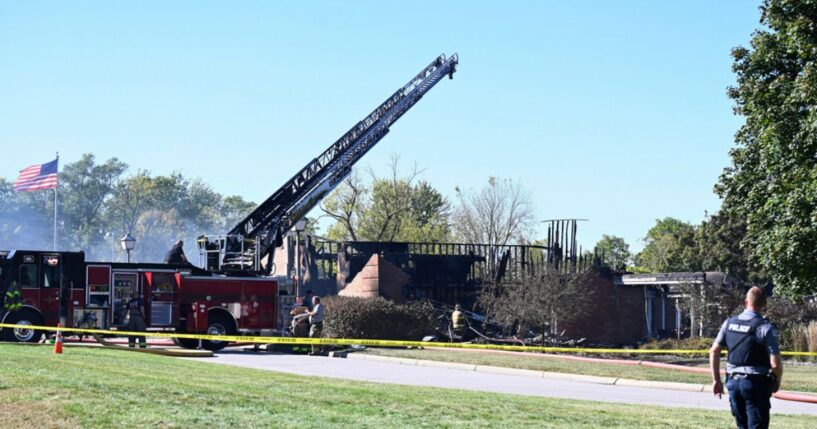 Law enforcement officers guard the area near where the attack took place at a Latter-day Saints church in Grand Blanc, Michigan, on Sept. 28, 2025.