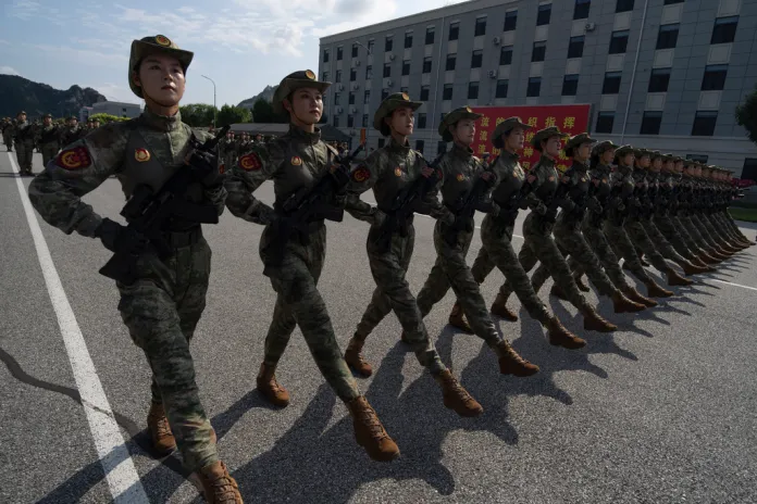 Female members of a Chinese Militia contingent march during drills.