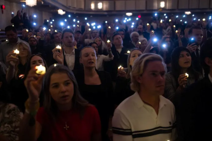 Attendees hold candles at Charlie Kirk's vigil in DC.