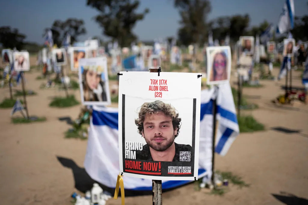 A poster depicting Israeli hostage Alon Ohel is displayed in Re'im, southern Israel at the Gaza border, Monday, Feb. 26, 2024 at a memorial site for the Nova music festival site where he was kidnapped to Gaza by Hamas on Oct. 7, 2023.