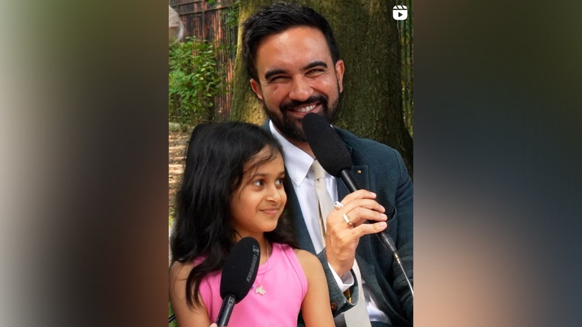 Mamdani speaking with a little girl