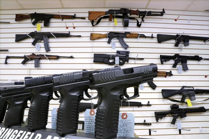 FILE - Assault weapons and handguns are seen for sale at Capitol City Arms Supply on Jan. 16, 2013, in Springfield, Ill. The Illinois Supreme Court will issue an opinion on the state's ban on the sale or possession of semi-automatic weapons of the type used in the 2022 Independence Day shooting in the Chicago suburb of Highland Park that killed seven and dozens of other mass shootings nationally. Rep. Dan Caulkins, a Decatur Republican, and other gun owners of Macon County filed the lawsuit contending the law not only violates the Second Amendment but equal protection of the laws because it exempts police and military from the ban. (AP Photo/Seth Perlman, File)