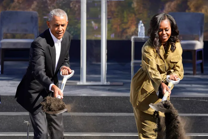 Former President Former President Barack Obama and former first lady Michelle Obama toss shovels of dirt during a groundbreaking ceremony for the Obama Presidential Center.