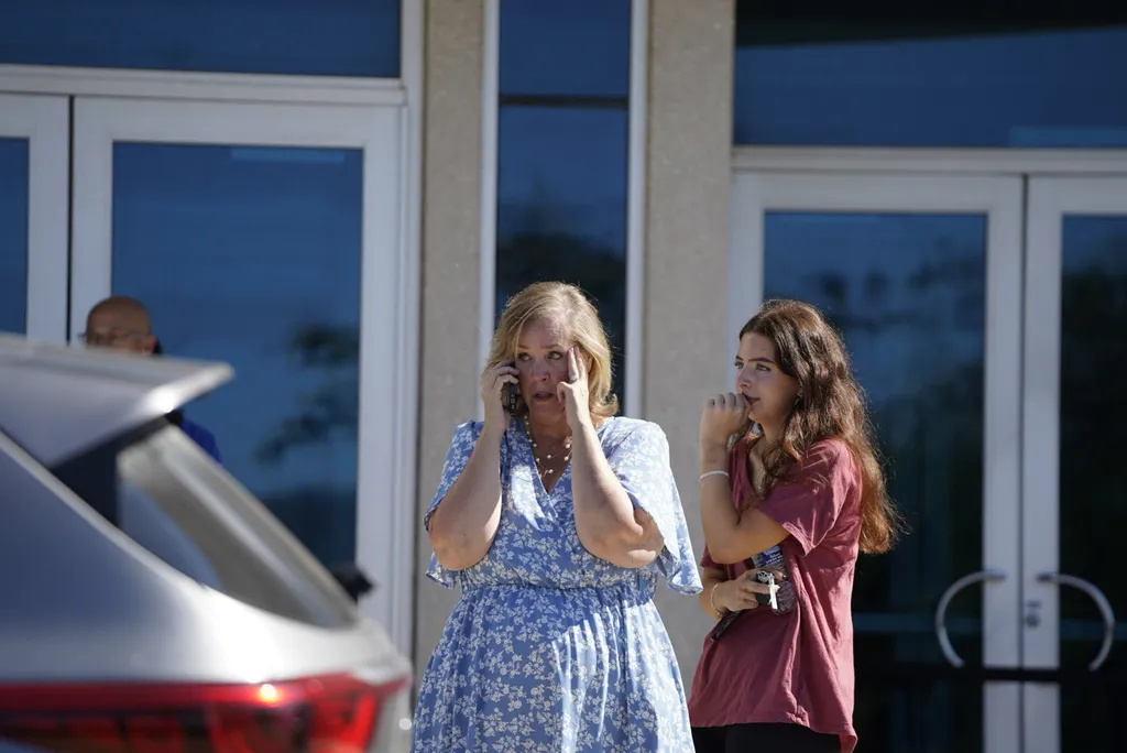 A woman talks on the phone outside.
